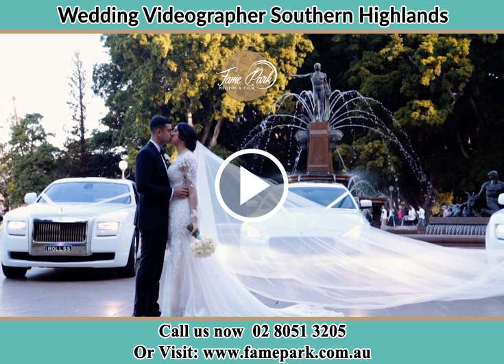 The Groom and the Bride Kissing in front of their bridal car Southern Highlands